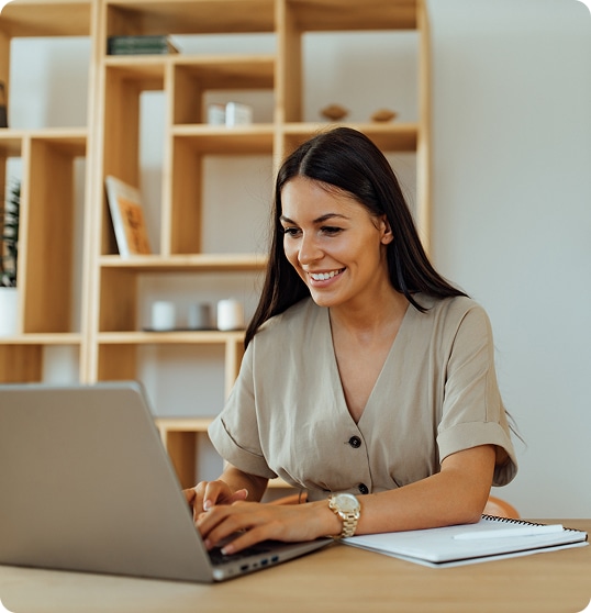 Smiling woman at laptop in home office