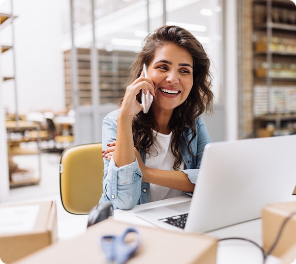 Smiling woman on phone in office