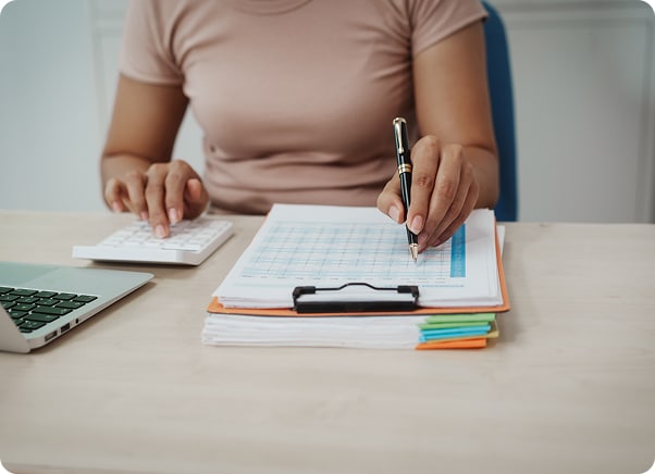 Woman sitting at desk with calculator